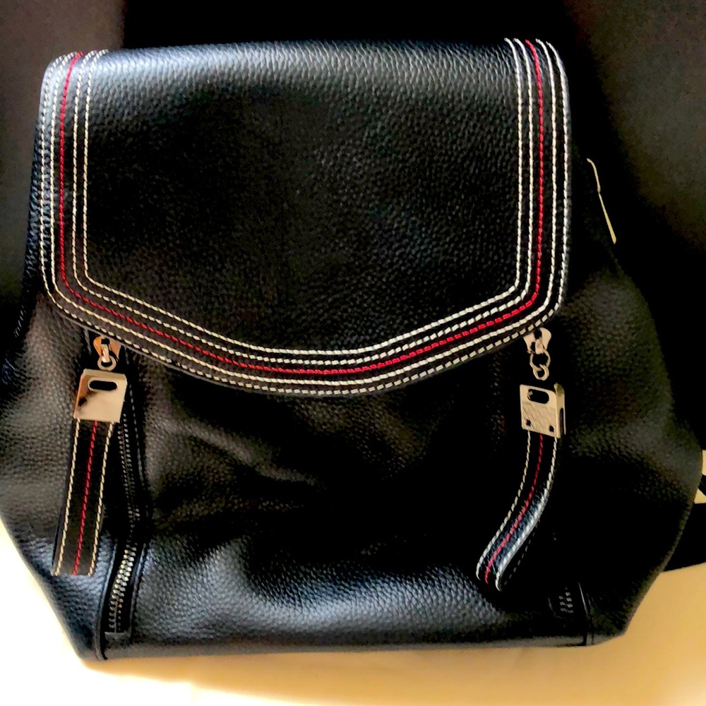 Black mini backpack. Zippered pockets inside and cellphone pocket.